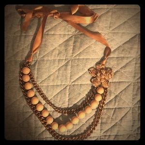 A bronze statement necklace with crystal flower